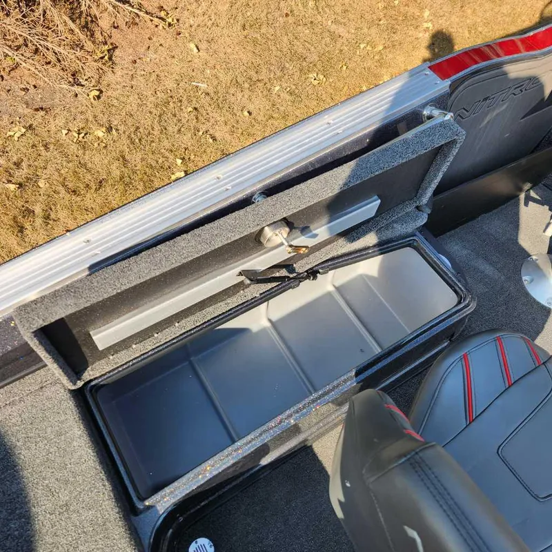 Slide: The Image of 2024 Nitro ZV20 Pro boat storage compartment with open lid, showcasing interior space. - 12