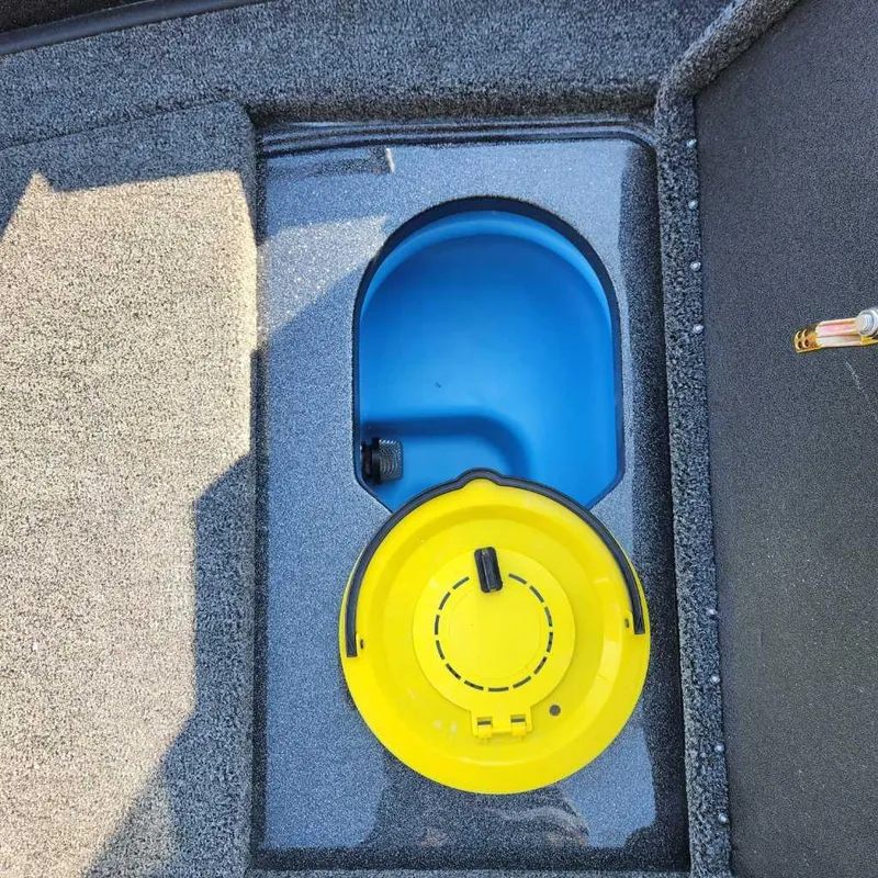 Slide: The Image of 2024 Nitro ZV20 Pro boat storage compartment with blue and yellow lids. - 14