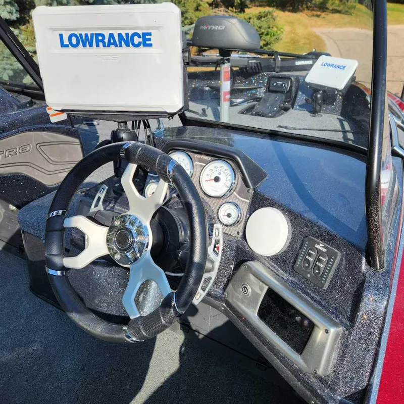 Slide: The Image of 2024 Nitro ZV20 Pro boat dashboard with Lowrance electronics and modern steering wheel. - 7