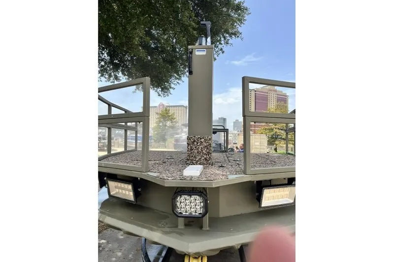 Slide: The Image of 2025 Tracker Grizzly 2072 CC Sportsman Kicker boat with urban backdrop and LED lights. - 4