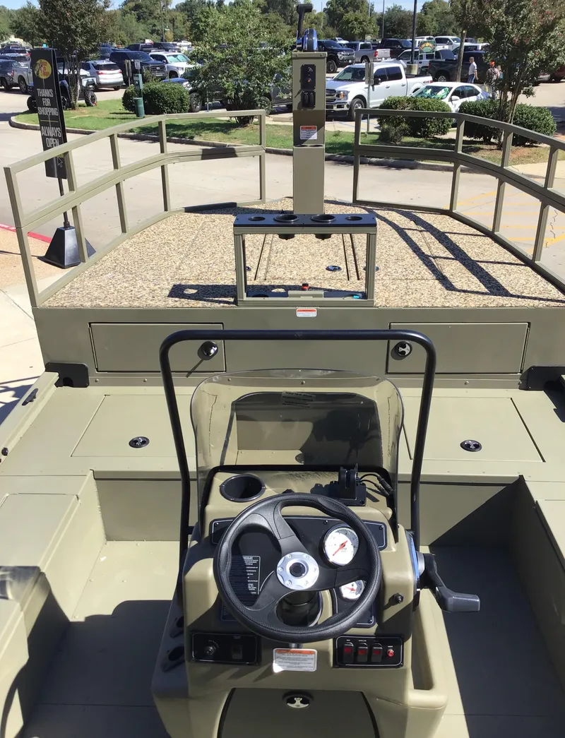 Slide: The Image of 2025 Tracker Grizzly 2072 CC Sportsman Kicker boat interior with steering console. - 3