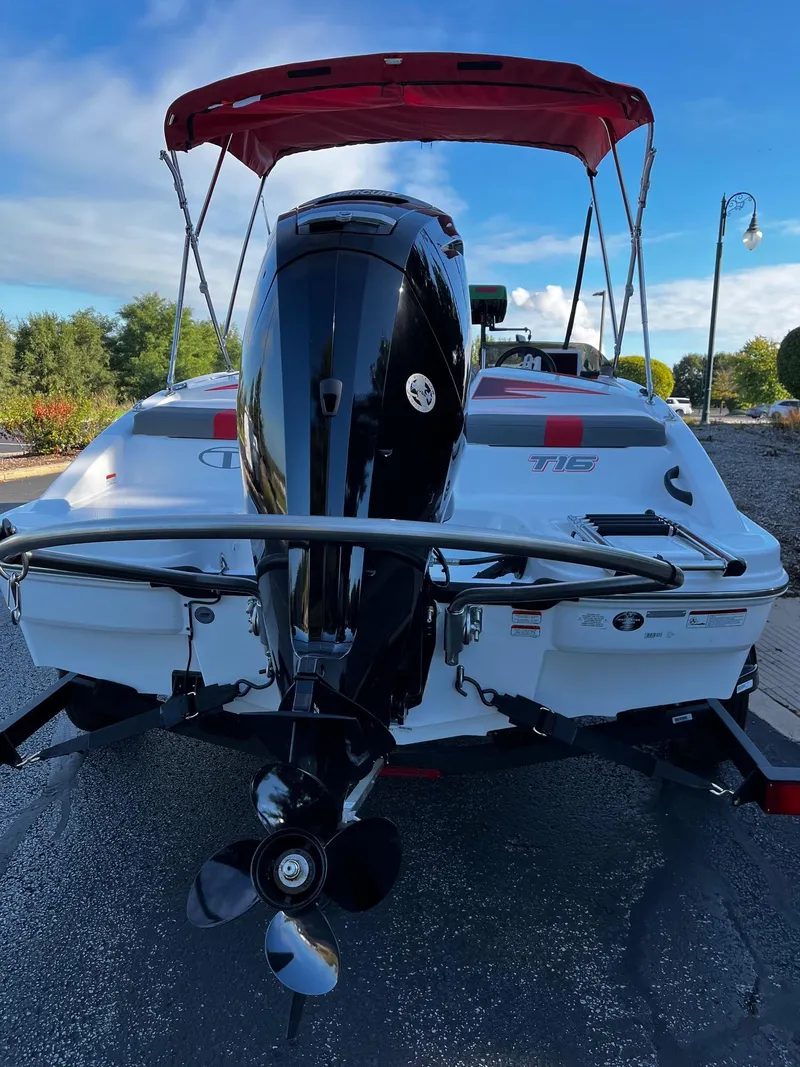 Slide: The Image of 2024 Tahoe T16 boat with red canopy and powerful outboard motor. - 2