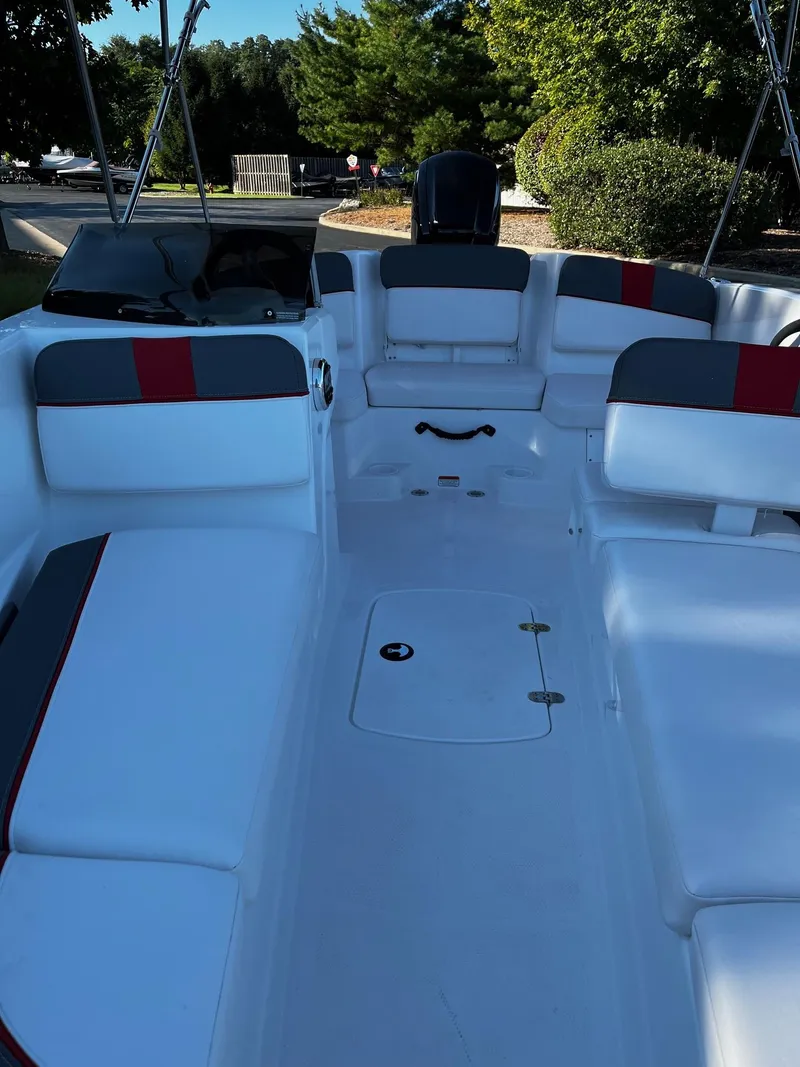 Slide: The Image of 2024 Tahoe T16 boat interior with white and gray seating, red accents, and spacious layout. - 5