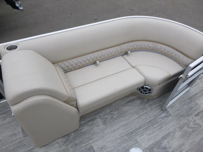 Slide: The Image of 2024 Ranger Reata 223C boat interior with beige seating and speaker. - 10