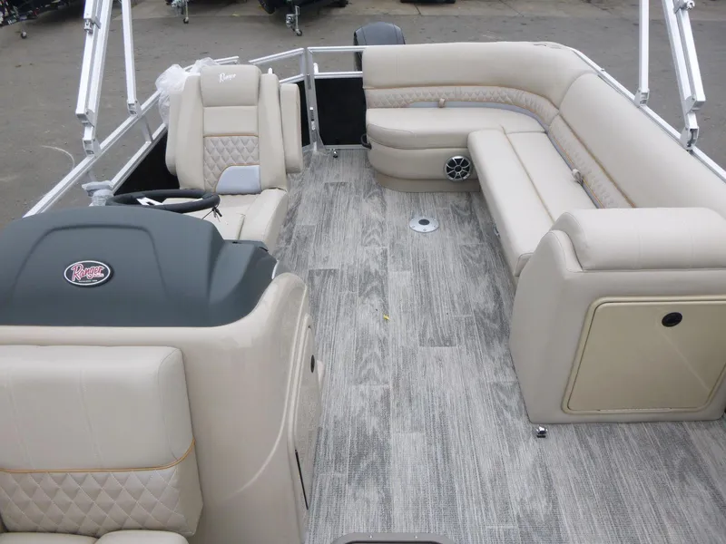 Slide: The Image of 2024 Ranger Reata 223C pontoon boat interior with beige seating and wood-style flooring. - 11