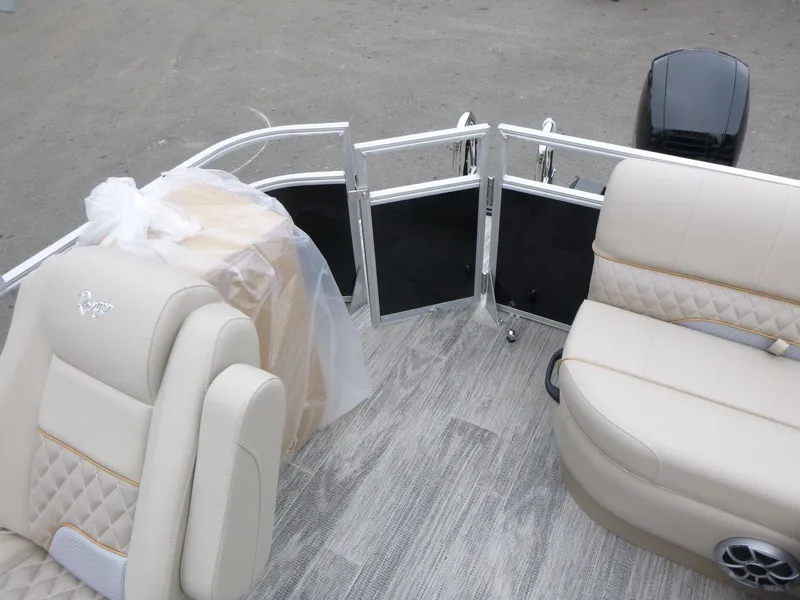Slide: The Image of 2024 Ranger Reata 223C boat interior with beige seating and modern flooring. - 14