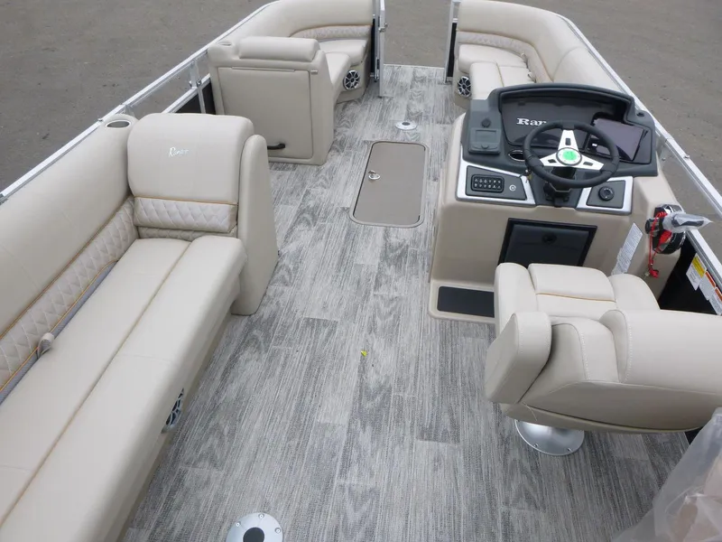 Slide: The Image of 2024 Ranger Reata 223C boat interior with beige seating and modern dashboard. - 16