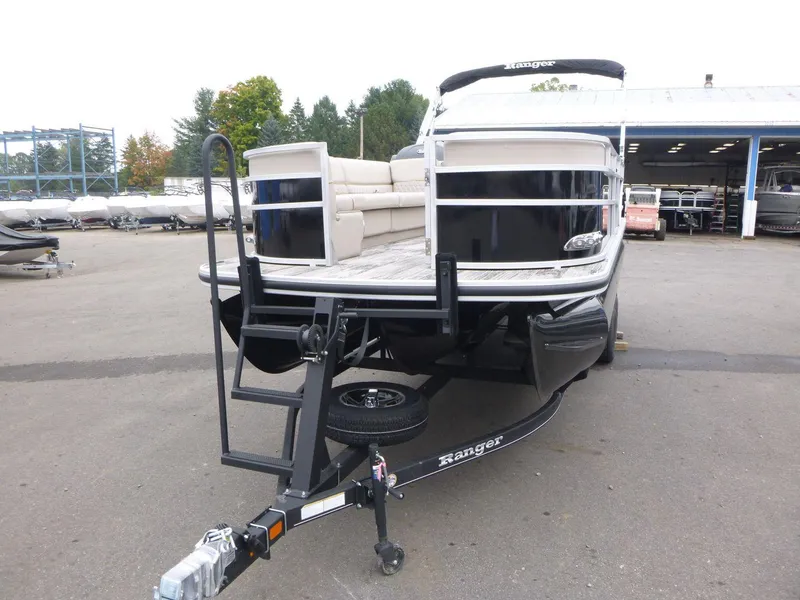 Slide: The Image of 2024 Ranger Reata 223C pontoon boat on trailer in outdoor showroom. - 6