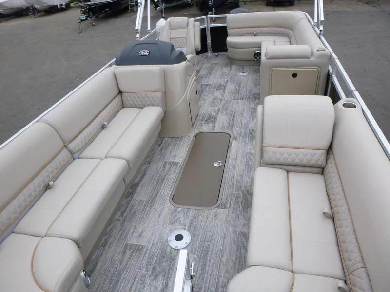Slide: The Image of 2024 Ranger Reata 223C pontoon boat with spacious beige seating and wood-style flooring. - 8