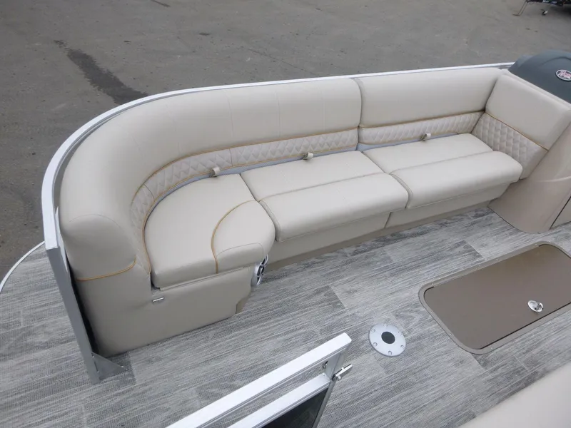 Slide: The Image of 2024 Ranger Reata 223C boat interior with beige seating and wood-style flooring. - 9