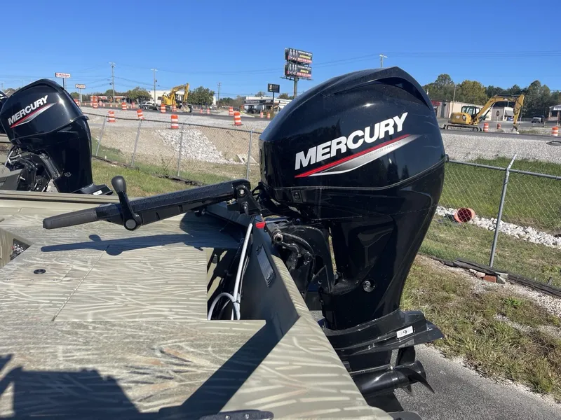 Slide: The Image of 2025 Tracker Grizzly 1654 T Sportsman boat with Mercury outboard motor in outdoor setting. - 4