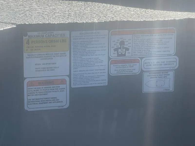 Slide: The Image of Capacity and safety labels on 2025 Tracker Grizzly 1654 T Sportsman boat. - 8