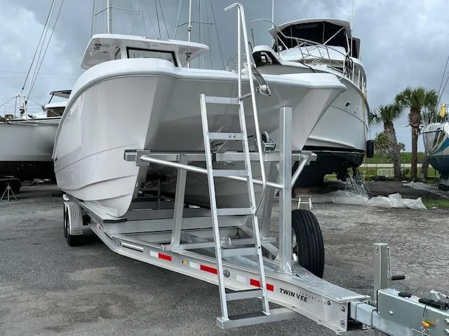 Slide: The Image of 2025 Twin Vee 280 GFX2 CC boat on trailer, parked in marina. - 18