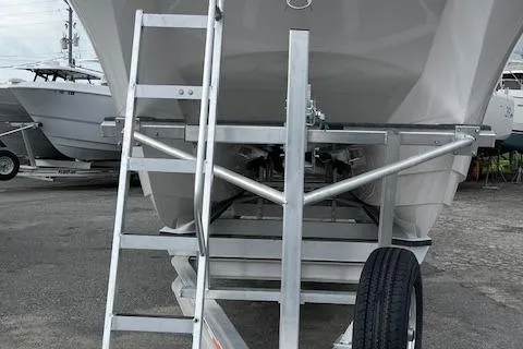 Slide: The Image of 2025 Twin Vee 280 GFX2 CC boat on trailer, front view with ladder. - 19