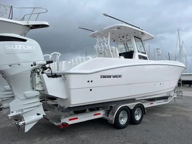 Slide: The Image of 2025 Twin Vee 280 GFX2 CC boat on trailer with Suzuki outboard motor. - 21