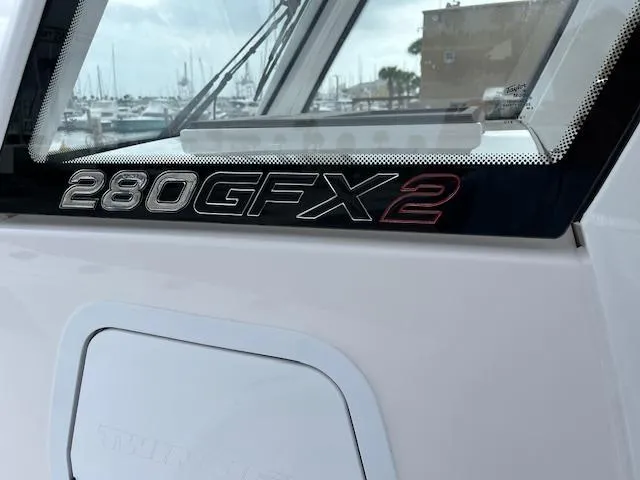 Slide: The Image of Close-up of 2025 Twin Vee 280 GFX2 CC boat model nameplate. - 28