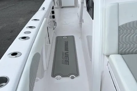 Slide: The Image of 2025 Twin Vee 280 GFX2 CC boat interior with rod holders and seating. - 31