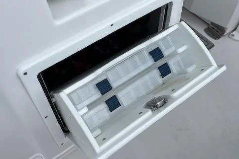 Slide: The Image of Twin Vee 280 GFX2 CC 2025 boat storage compartment with organized tackle trays. - 33