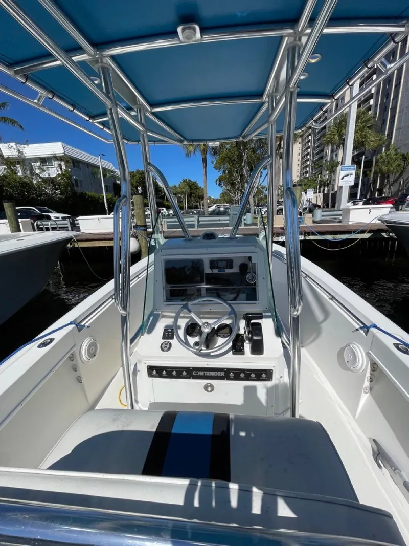 Slide: The Image of 1995 Contender 21 Open boat interior with steering console and blue canopy. - 4