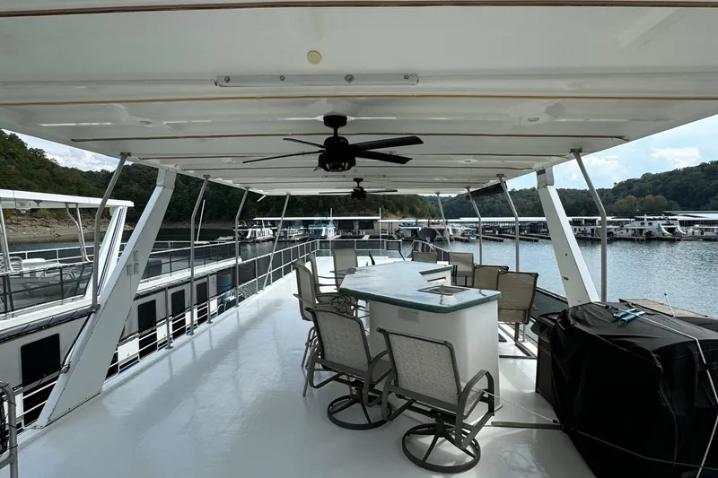 Slide: The Image of Upper deck of 1999 Sumerset 16 X 80 houseboat with seating and ceiling fans. - 14