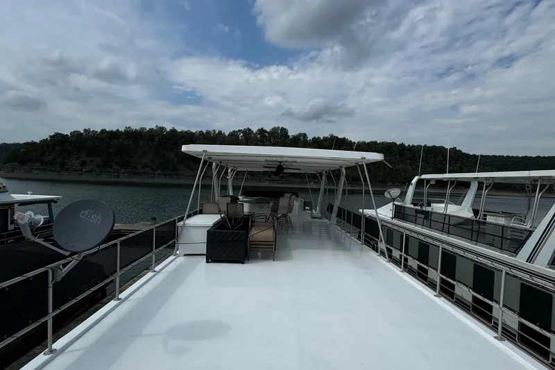 Slide: The Image of 1999 Sumerset 16 X 80 houseboat with spacious deck, docked on a scenic lake. - 15