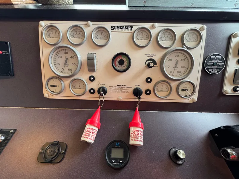 Slide: The Image of Control panel of a 1999 Sumerset 16 X 80 houseboat with gauges and switches. - 16