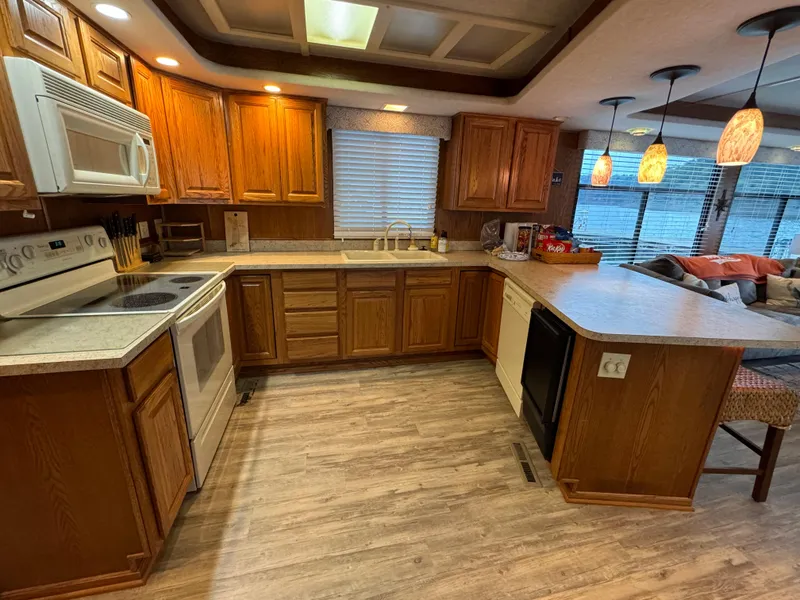 Slide: The Image of Spacious kitchen in 1999 Sumerset 16 X 80 houseboat with wooden cabinets and modern appliances. - 21