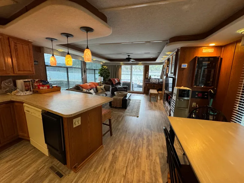 Slide: The Image of Interior of a 1999 Sumerset 16 X 80 houseboat with modern kitchen and cozy living area. - 22