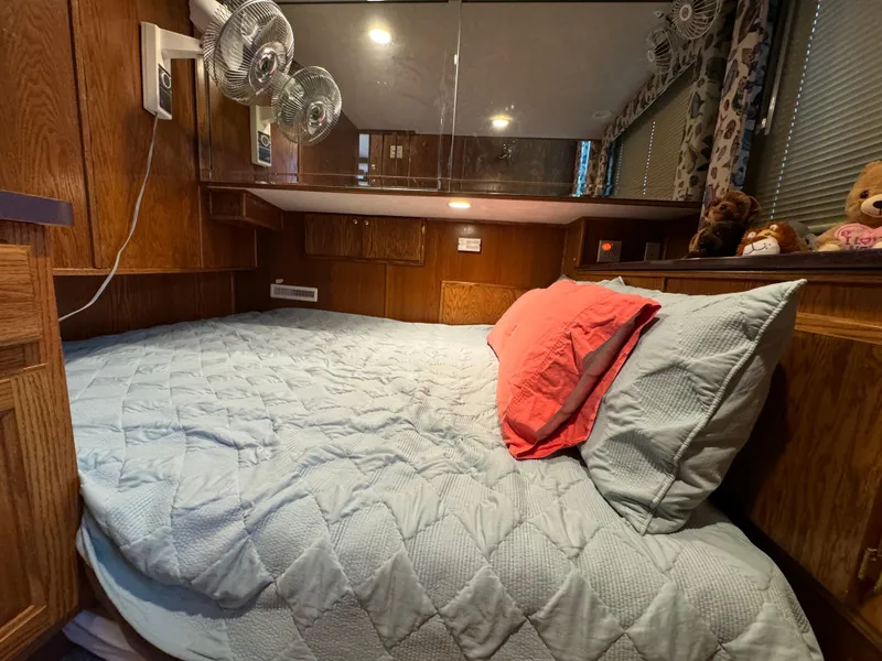 Slide: The Image of Cozy bedroom in 1999 Sumerset 16 X 80 houseboat with wood paneling and plush bedding. - 29