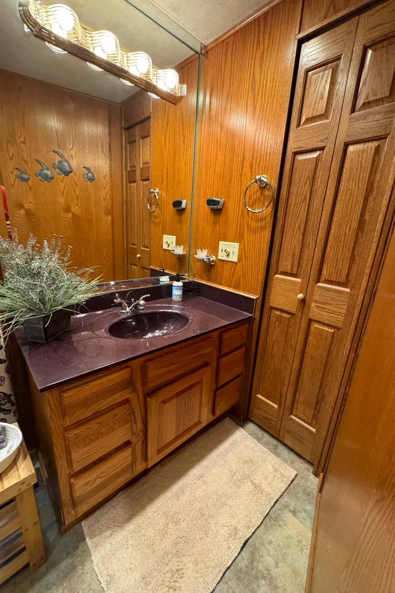 Slide: The Image of Bathroom with wooden cabinets and mirror in 1999 Sumerset 16 X 80 houseboat. - 34