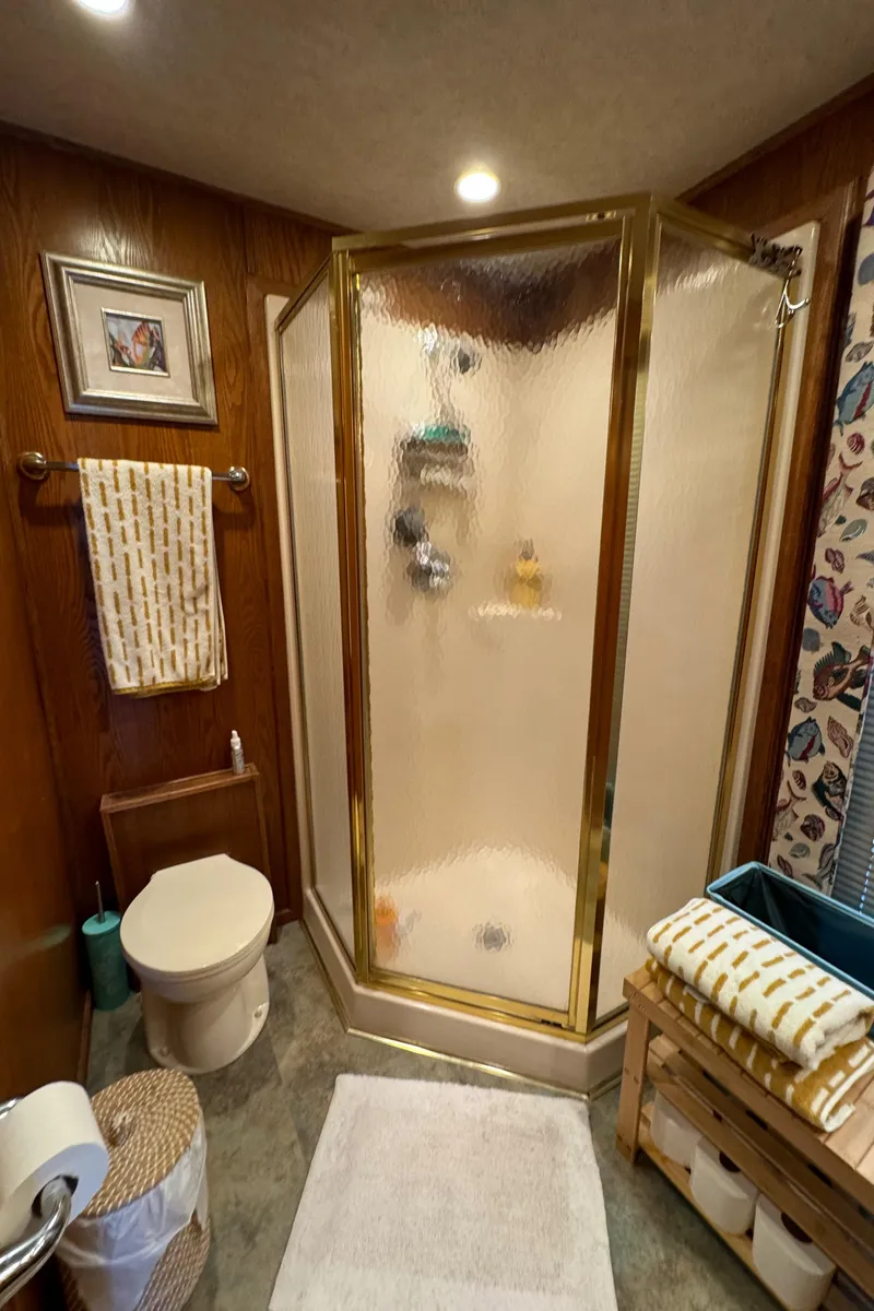 Slide: The Image of Bathroom in 1999 Sumerset 16 X 80 houseboat with shower, toilet, and wooden accents. - 35