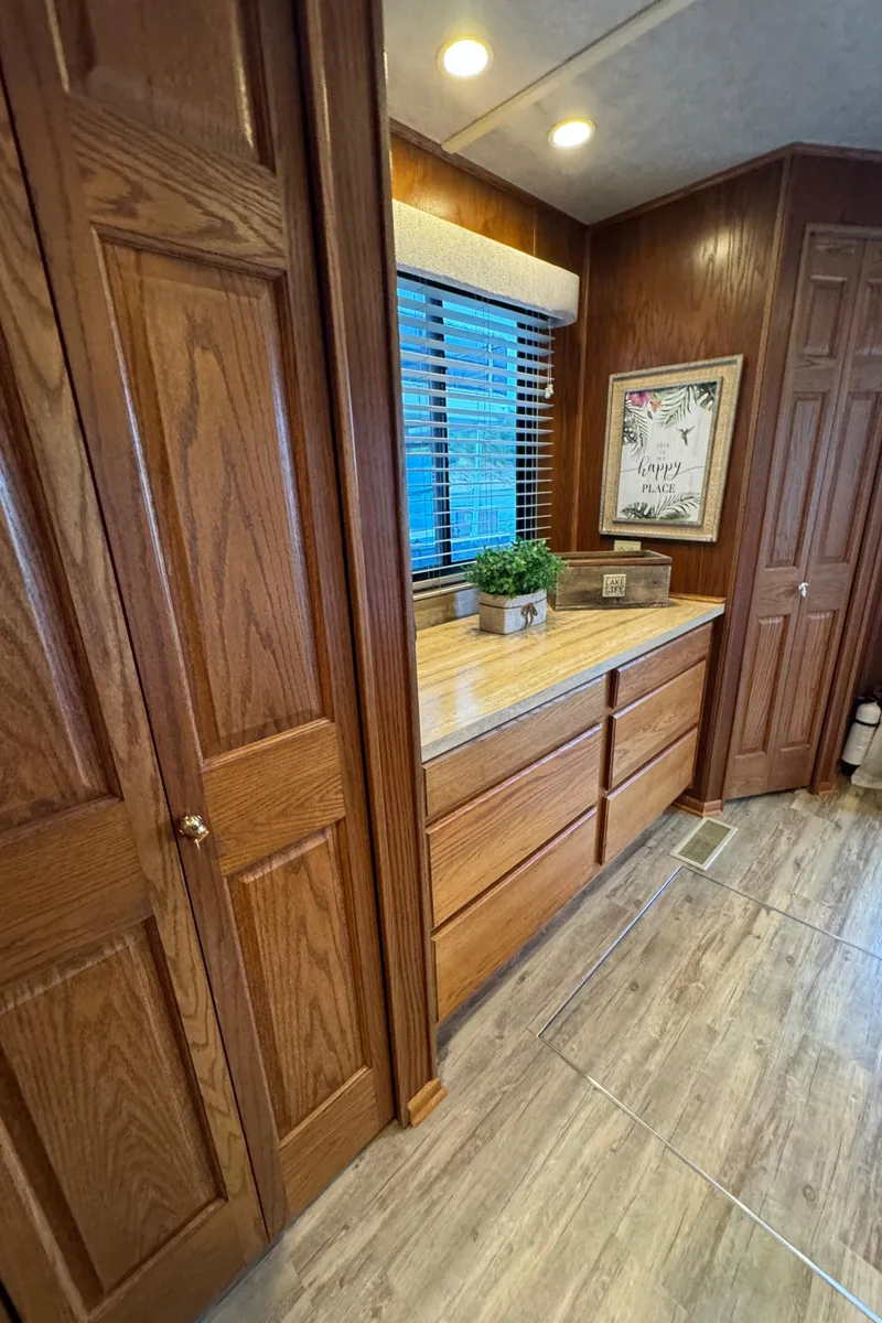 Slide: The Image of 1999 Sumerset 16 X 80 interior with wooden cabinets and decor. - 38