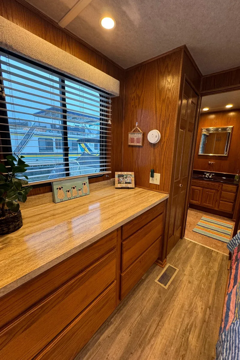 Slide: The Image of Interior of 1999 Sumerset 16 X 80 houseboat with wood cabinetry and natural light. - 39