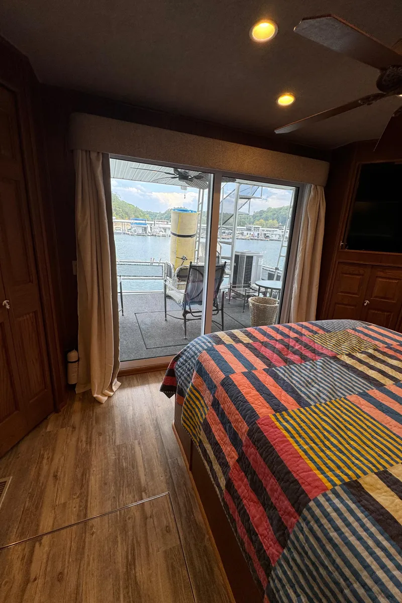 Slide: The Image of Bedroom interior of 1999 Sumerset 16 X 80 houseboat with lake view. - 40