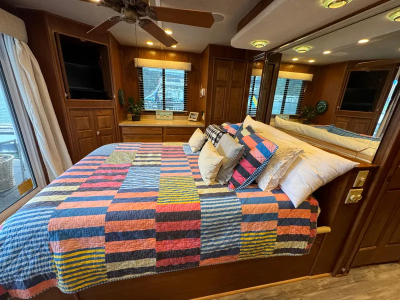 Slide: The Image of Cozy bedroom in 1999 Sumerset 16 X 80 houseboat with colorful quilt and wooden decor. - 41