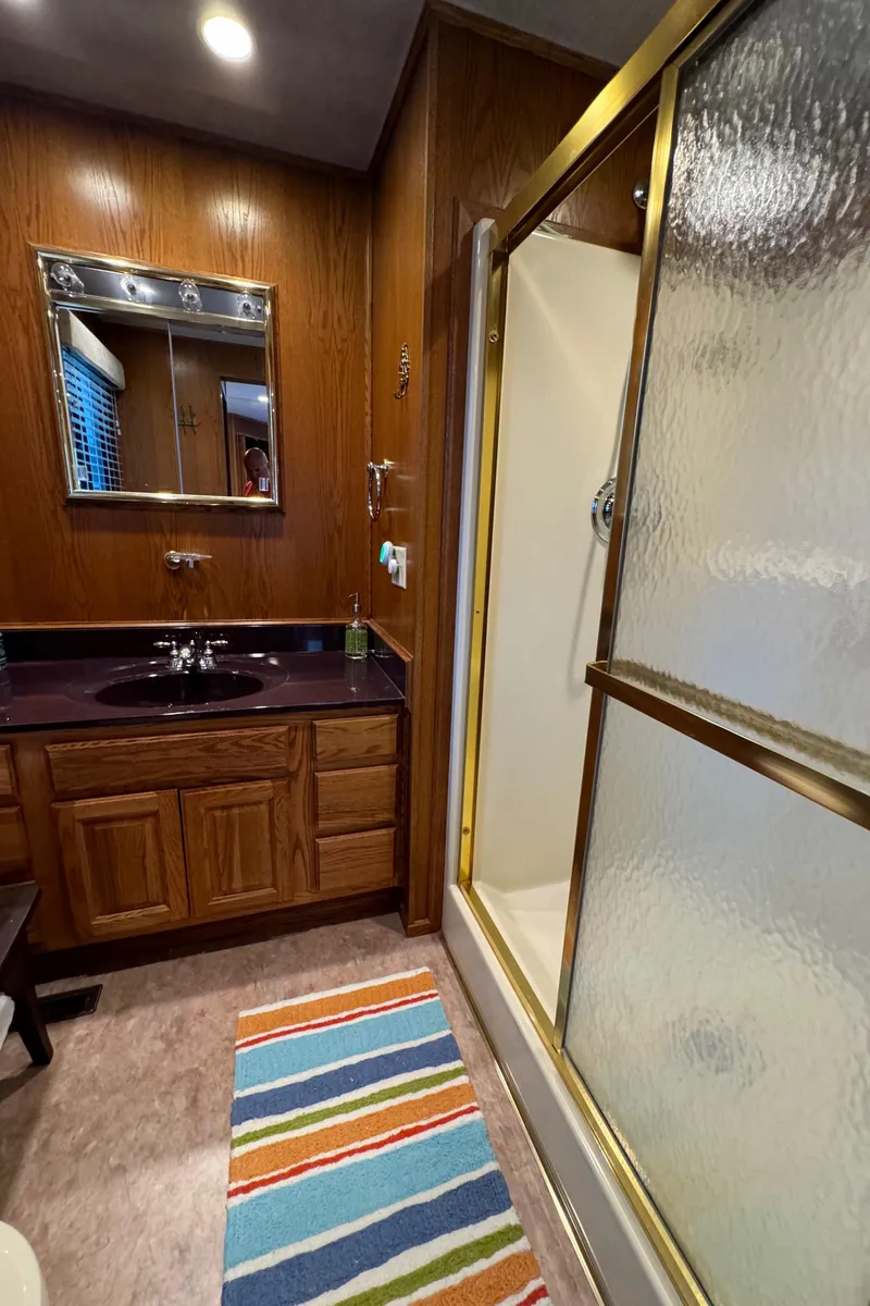Slide: The Image of Bathroom in 1999 Sumerset 16 X 80 houseboat with wood cabinets and glass shower. - 42
