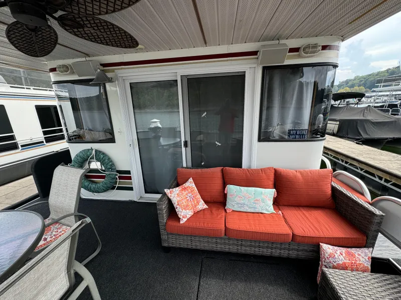 Slide: The Image of Outdoor seating area on a 1999 Sumerset 16 X 80 houseboat with red cushions. - 5