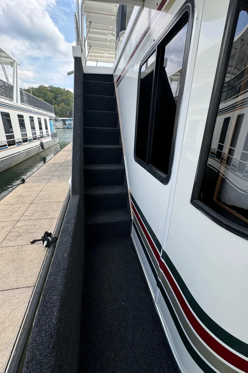 Slide: The Image of 1999 Sumerset 16 X 80 houseboat with exterior stairs and dock view. - 8