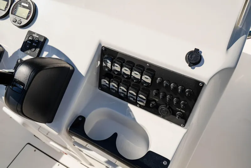 Slide: The Image of Edgewater 188CC 2025 boat dashboard with controls and gauges. - 14