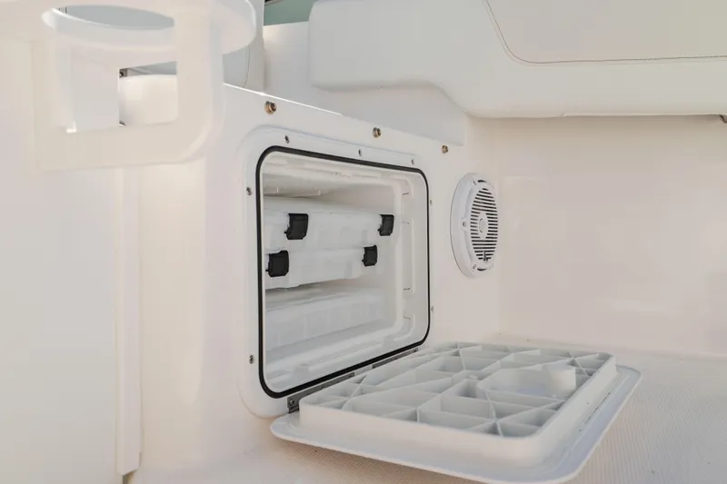 Slide: The Image of Open storage compartment on 2025 Edgewater 188CC boat interior. - 24