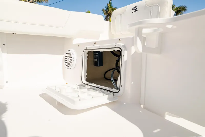 Slide: The Image of 2025 Edgewater 188CC boat storage compartment with open hatch and visible wiring. - 26