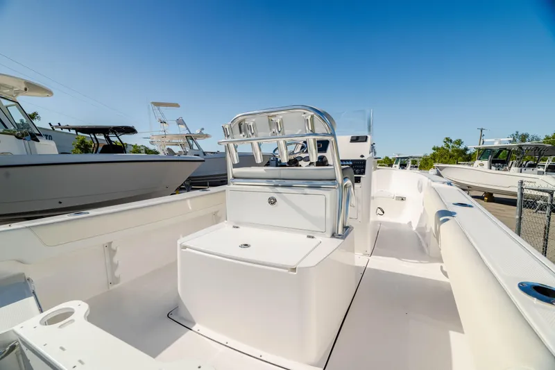 Slide: The Image of 2025 Edgewater 188CC boat interior with seating and console, under clear blue sky. - 3