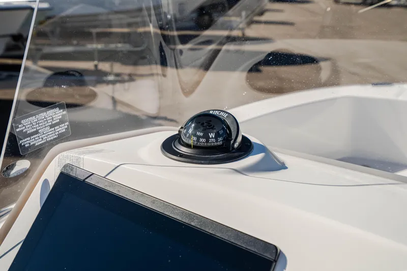 Slide: The Image of Compass on 2025 Edgewater 188CC boat dashboard, with clear windshield view. - 8