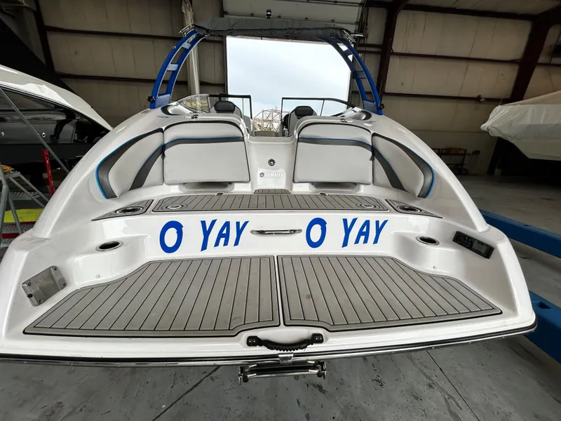 Slide: The Image of 2020 Yamaha AR 240 boat with "O YAY" text on the deck in a warehouse. - 16