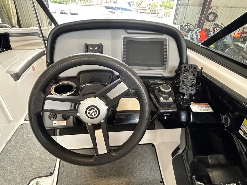 Slide: The Image of 2020 Yamaha AR 240 boat dashboard with steering wheel and control panel. - 6