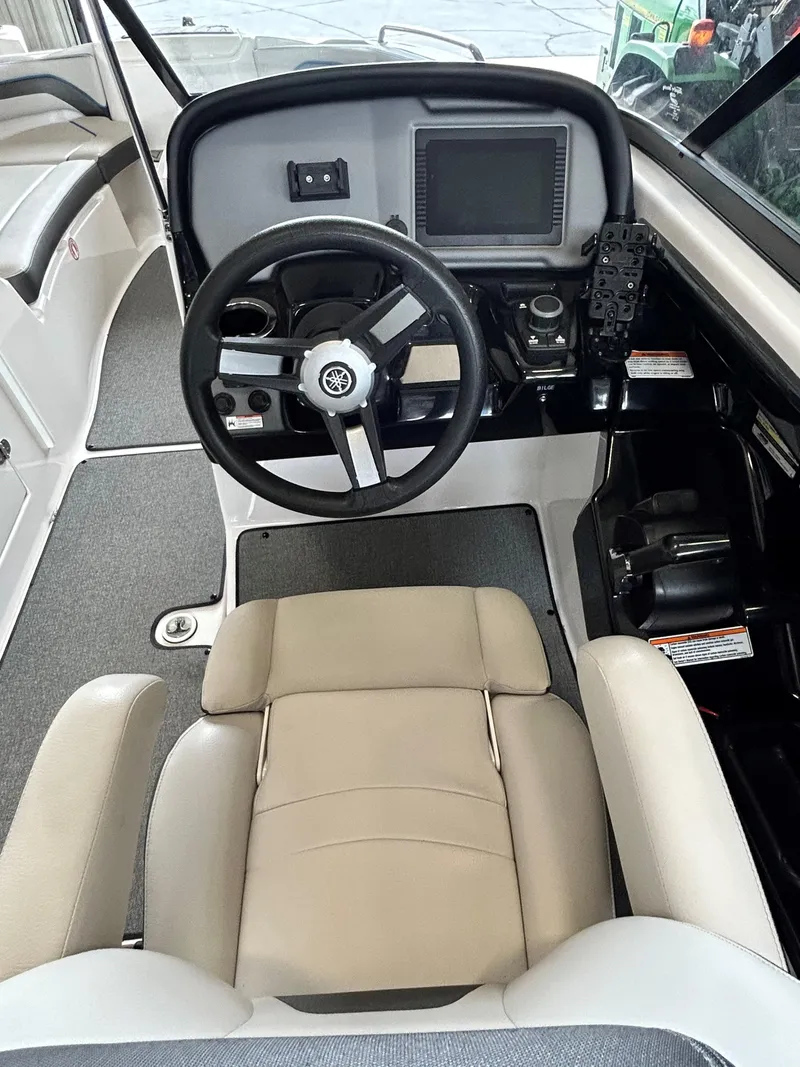 Slide: The Image of 2020 Yamaha AR 240 boat cockpit with steering wheel and control panel. - 7