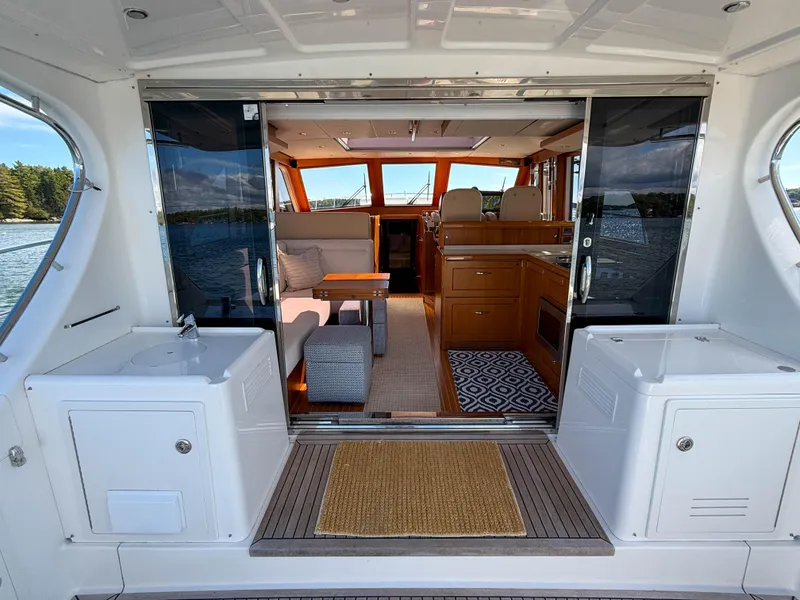 Slide: The Image of Interior view of 2014 Grand Banks 50 Eastbay SX yacht, featuring elegant seating and cabinetry. - 10