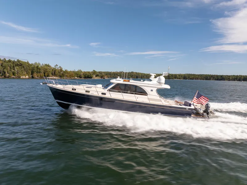 Slide: The Image of 2014 Grand Banks 50 Eastbay SX cruising on a scenic lake. - 2