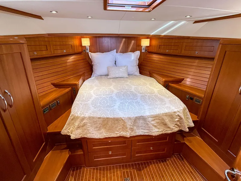 Slide: The Image of Luxurious 2014 Grand Banks 50 Eastbay SX cabin with elegant wood finish and cozy bedding. - 27
