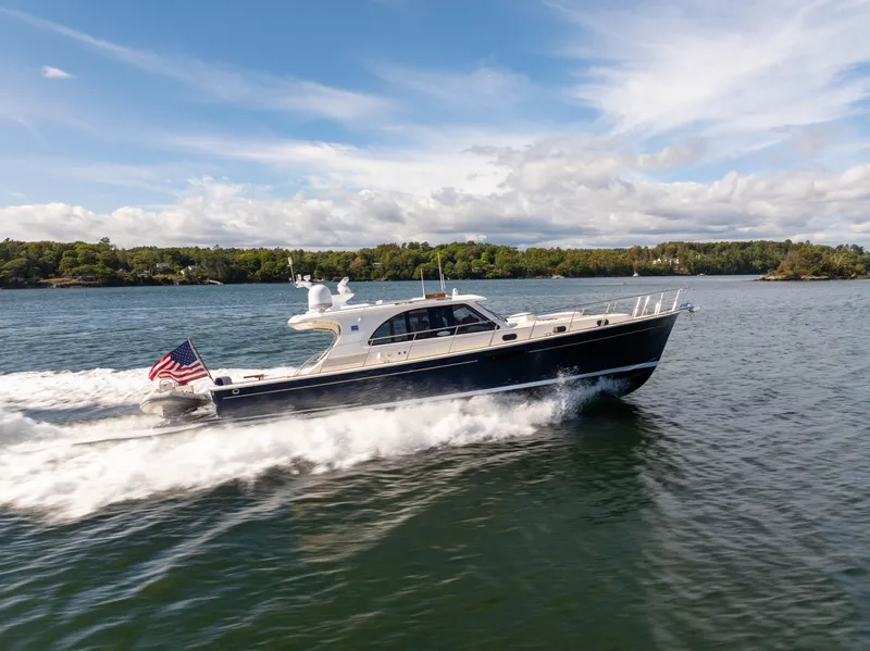 Slide: The Image of 2014 Grand Banks 50 Eastbay SX yacht cruising on a scenic lake. - 3